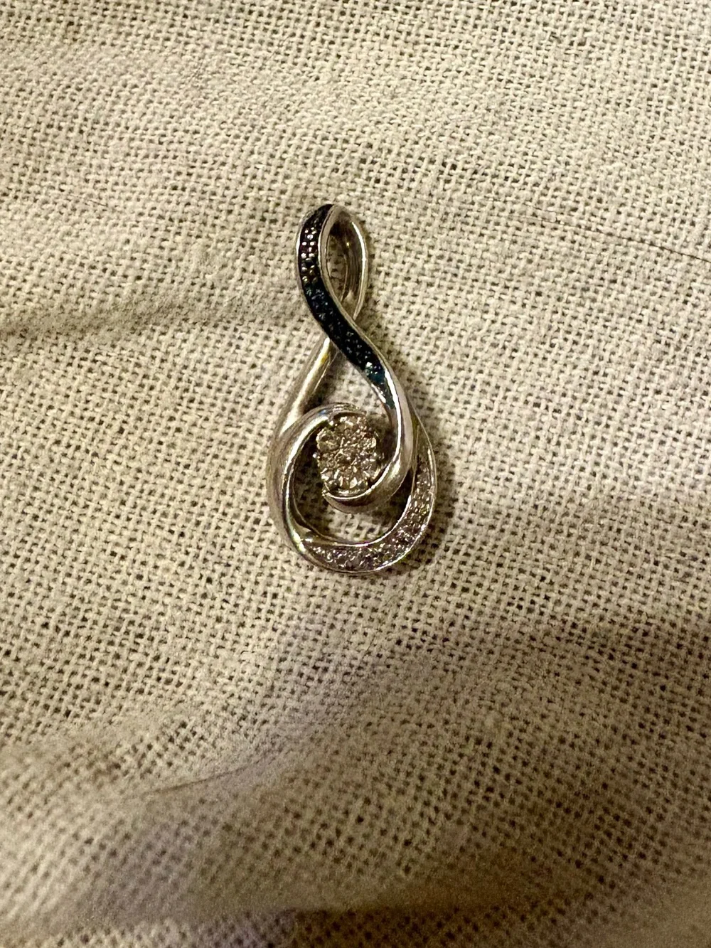 Black & white diamond accent cluster infinity pendant in sterling silver.